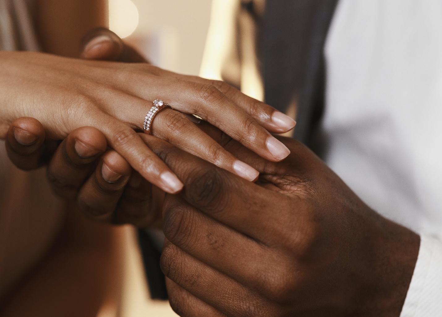 fiancé placing resized engagement ring on finger