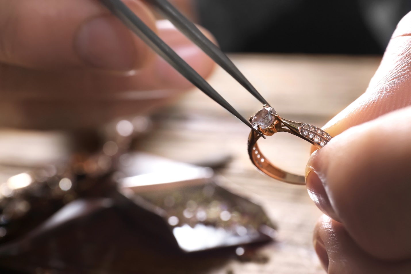 jeweler removing diamond from mount