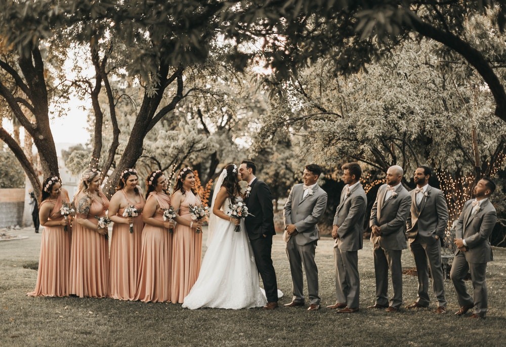 Bridesmaids and groomsmen around wedding couple