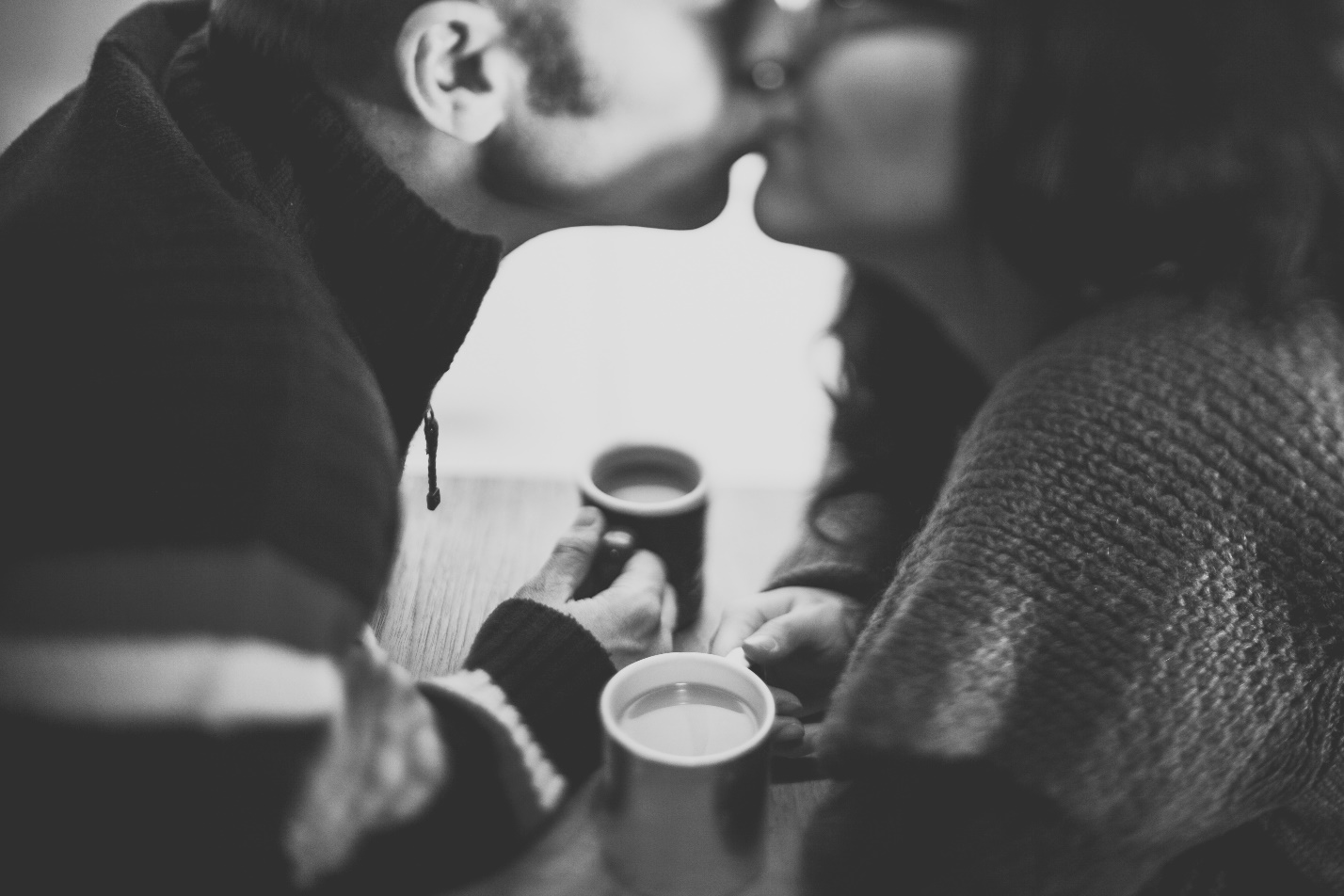 Couple Kissing Holding Coffee
