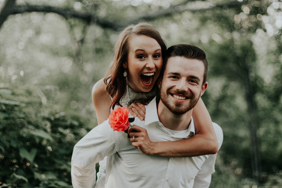 Man holding woman on his back