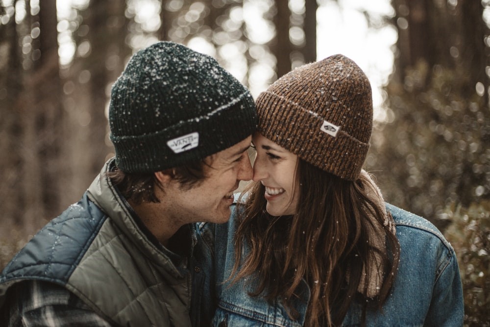 Man and woman touching noses in the snow