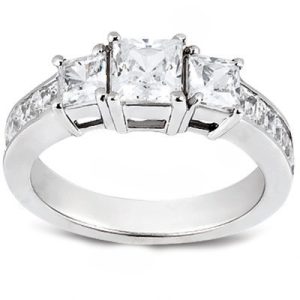 A three-stone engagement ring with a shiny silver band and clear, sparkling gemstones.