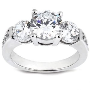 A silver engagement ring with a large central diamond and two smaller diamonds on either side.